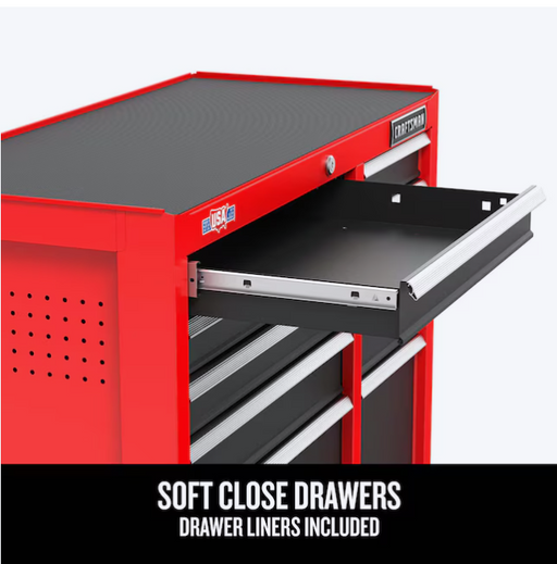 Gabinete rojo Craftsman con tapa negra y cajón inferior abierto